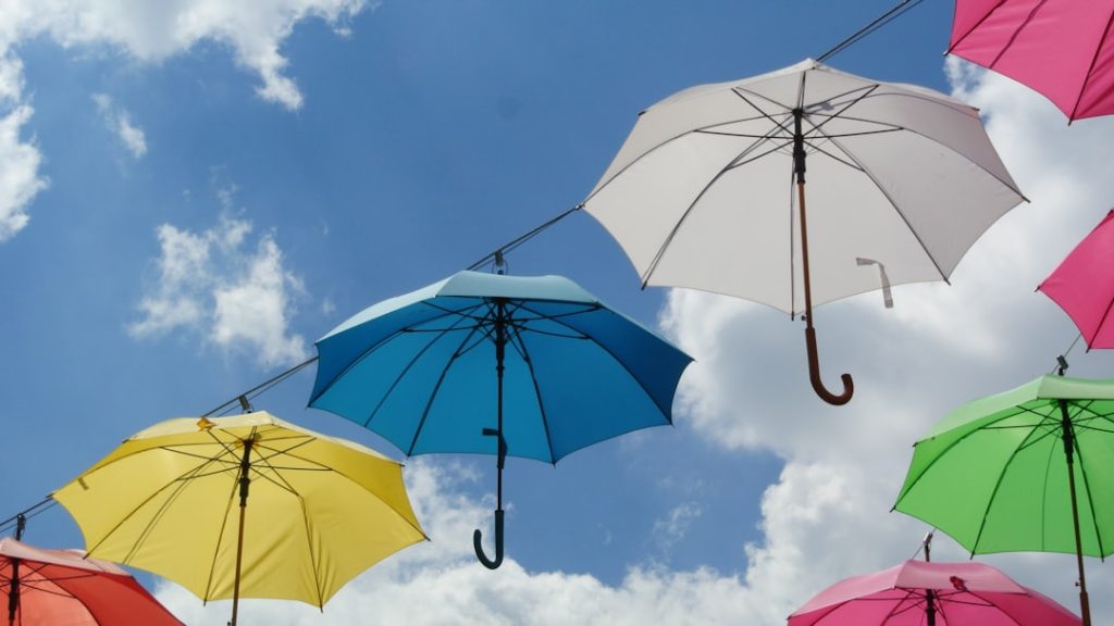 a-bunch-of-umbrellas-are-hanging-in-the-air-34ffvd8djy